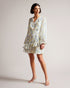 SUZIIEE-Dresses-Make every day a fashion show in SUZIIEE. Featuring our gorgeous poppy print and all the ruffles your heart desires, this versatile mini dress will take you from coffee mornings to dinner dates with ease.The fabric of this product is made with 30% recycled polyester. Using recycled polyester helps divert plastic waste from ending in landfills, and helps us to reduce our dependence on virgin materials. Mini dress Daisy print Long blouson sleeves Asymmetric ruffled hem Self tie neckline Zip fa